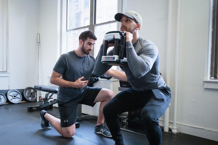 Physical therapist coaching an active adult through a strength exercise at Inspire Physical Therapy in Chico, California
